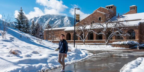 Student walking on campus on a snowy day