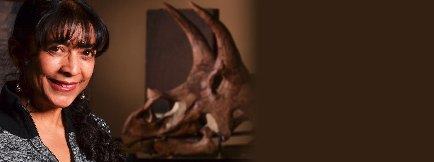Karen Chin standing next to Triceratops Skull in Paleontology Hall