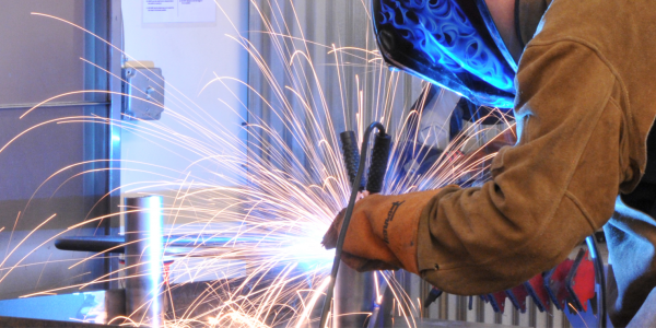 Student welding in the Creative Labs Center