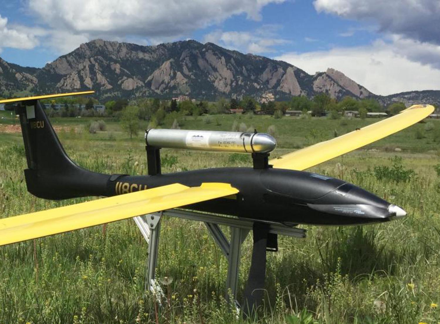 Unmanned flying vehicle parked in a field near Boulder