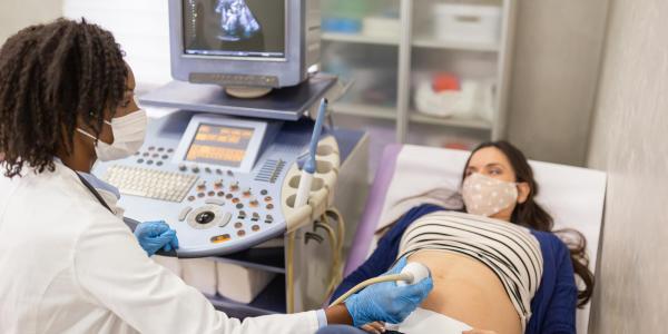 Doctor performing a sonogram on a patient