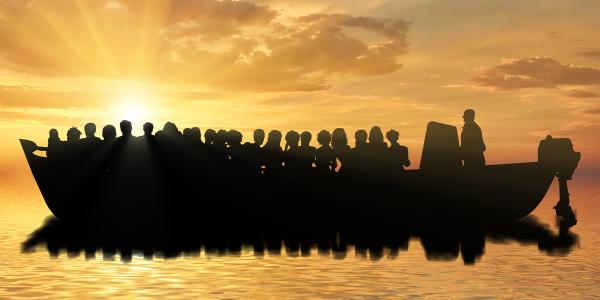 Silhouette of people on a boat at sea