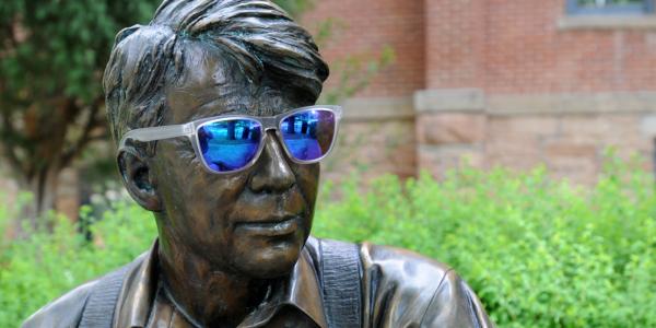 Robert Frost statue wearing sunglasses