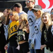 Current and alumni cheerleaders sing the CU Alma Mater song before a football game