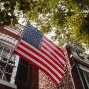 American flag in front of an old brick home
