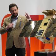Bradley Cheetham with a model of the successful CAPSTONE satellite.