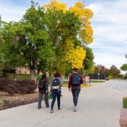 Three students walking on campus