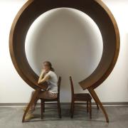 Woman sits unique circle table