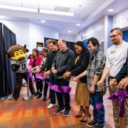Colorado Gov. Jared Polis, Chip the buffalo mascot and several campus affiliates cut the ribbon at the gaming center grand opening