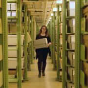 CU Boulder archivist Jane Thaler carries a box of CWA archives