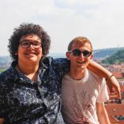 Two students in front of Prague, Czech Republic, cityscape