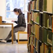 Student reading a book in Norlin Library
