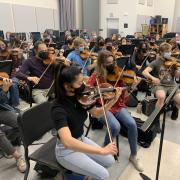 violin section rehearsing for concert