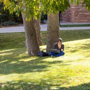a student studying outside on campus