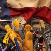 manual labor tools laid on an American flag